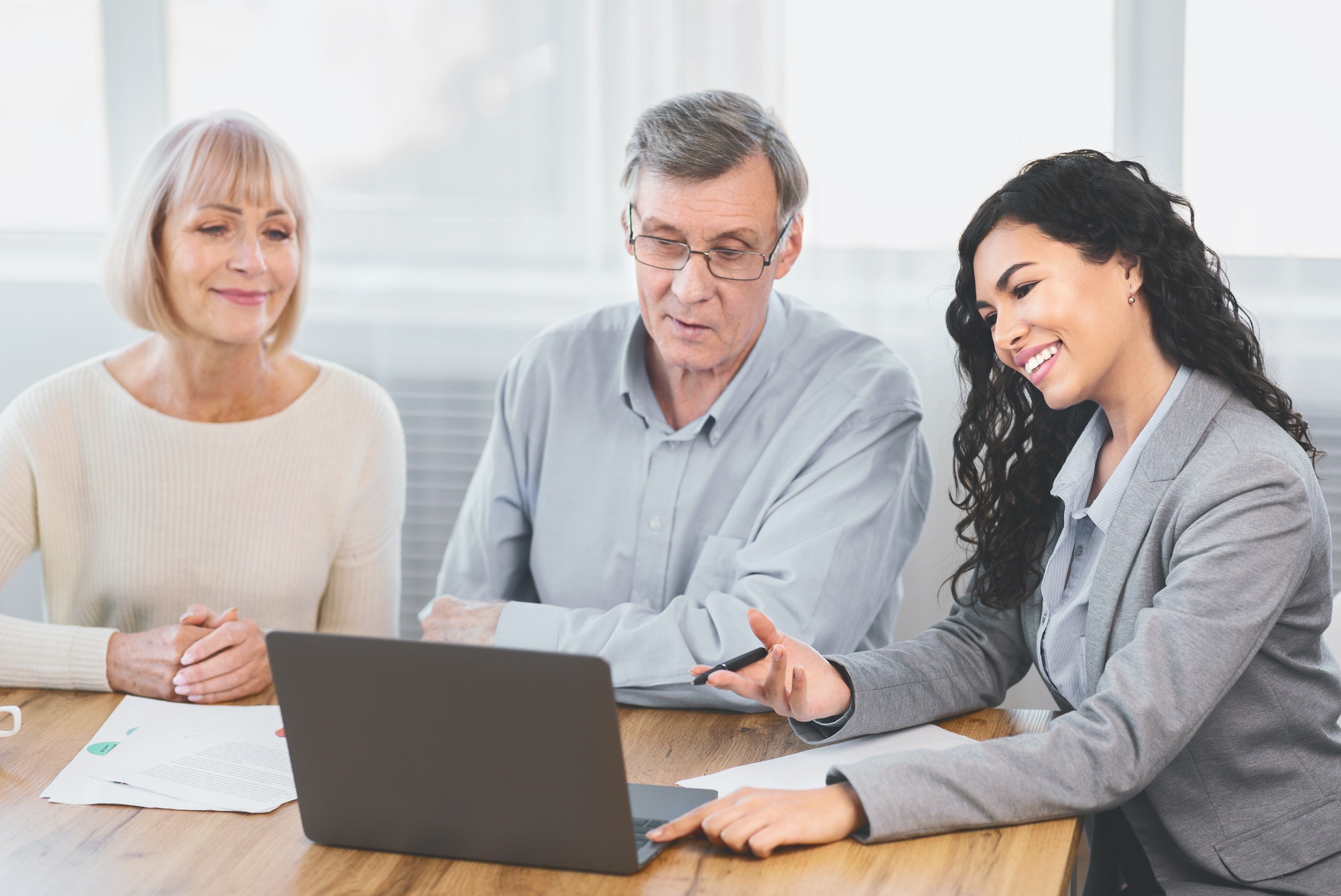 Elderly couple consulting with financial advisor at home